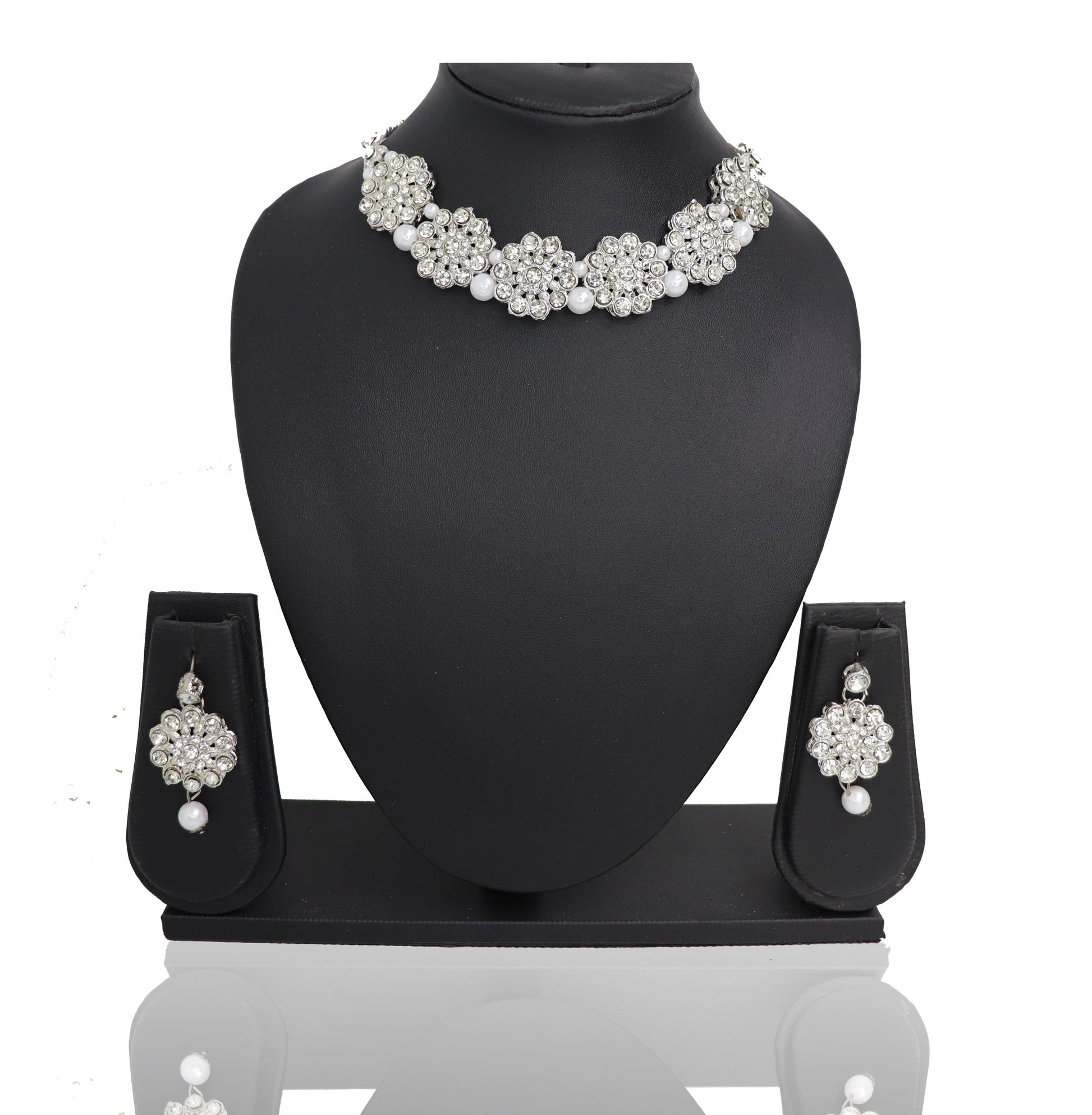A choker necklace set with oxidised silver finish and pearl embellishments displayed on a mannequin bust.