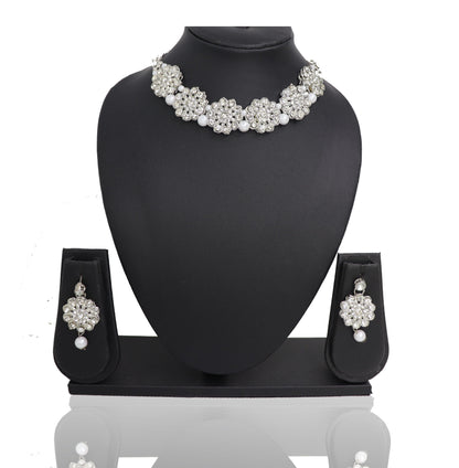 A choker necklace set with oxidised silver finish and pearl embellishments displayed on a mannequin bust.