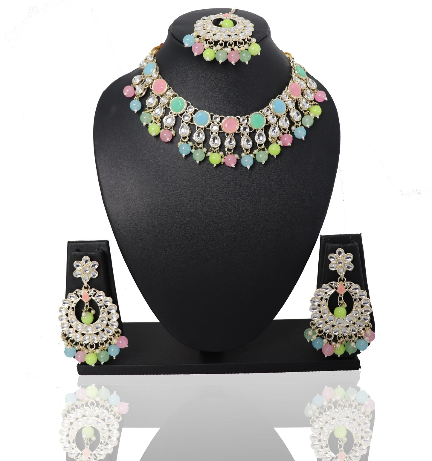 A set of jewelry featuring a multicolored choker necklace, matching earrings, and a maangtikka, displayed on a black mannequin.