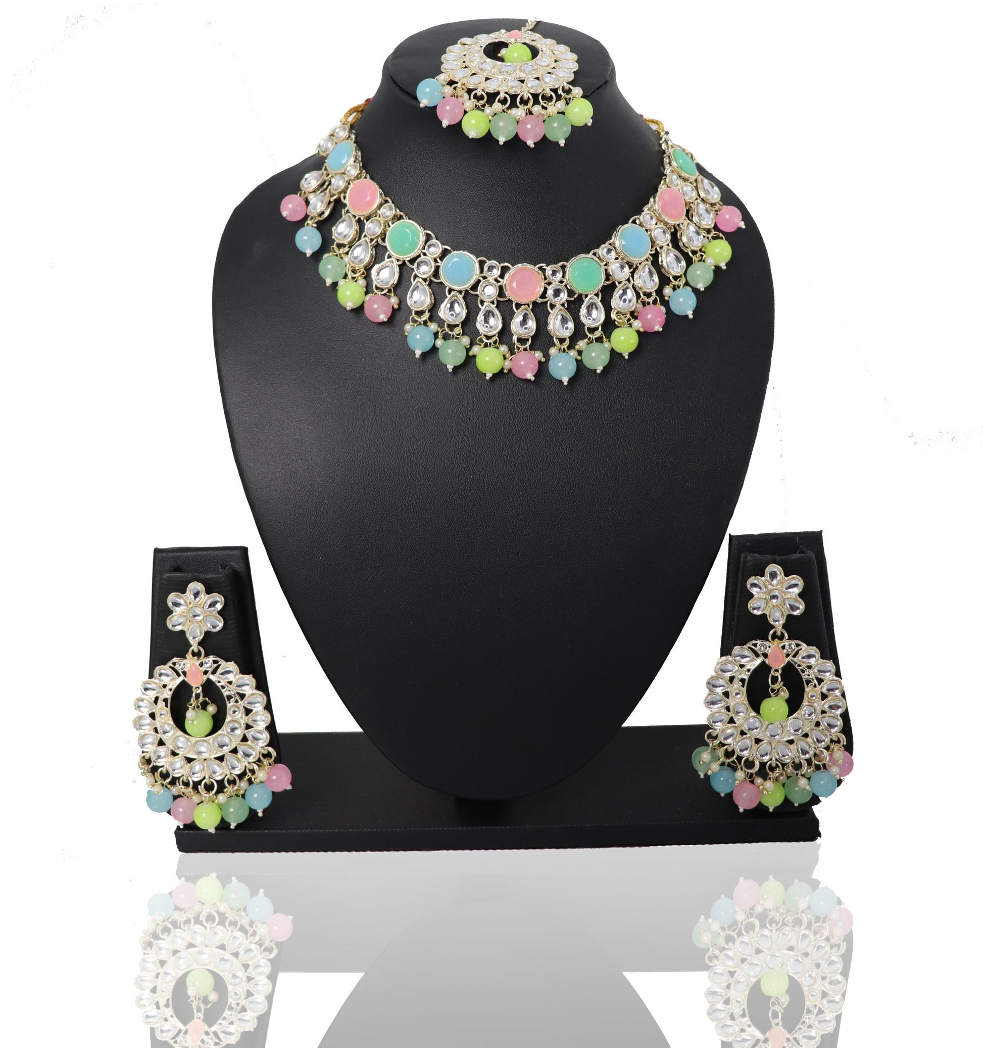 A set of jewelry featuring a multicolored choker necklace, matching earrings, and a maangtikka, displayed on a black mannequin.