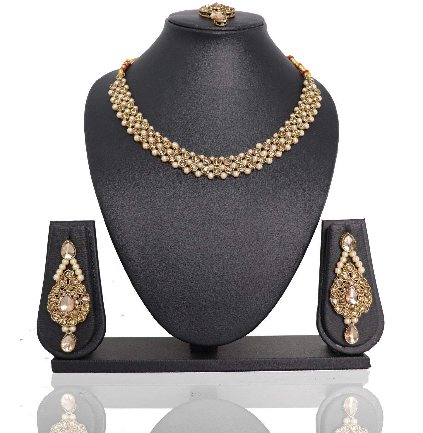 A golden Payal Kundan Choker Set displayed on a black mannequin bust, including a necklace with pendants and earrings with pendants.