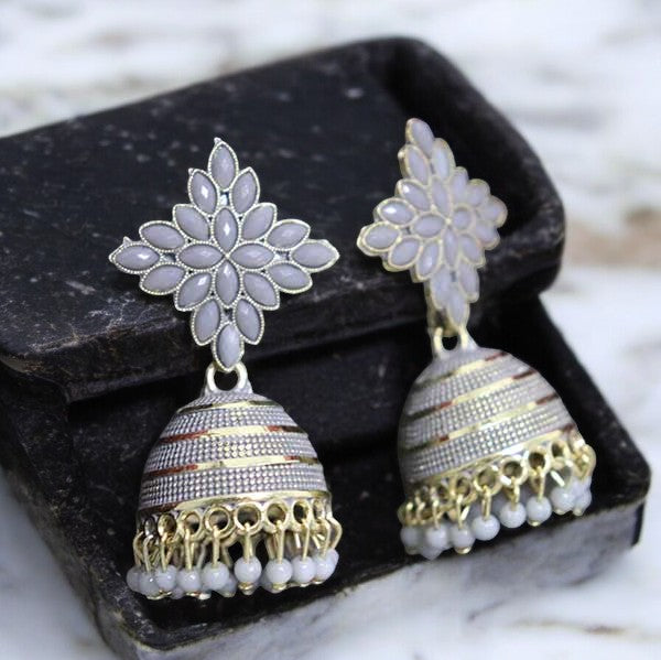 A pair of gray floral handcrafted jhumka earrings displayed in a black box.