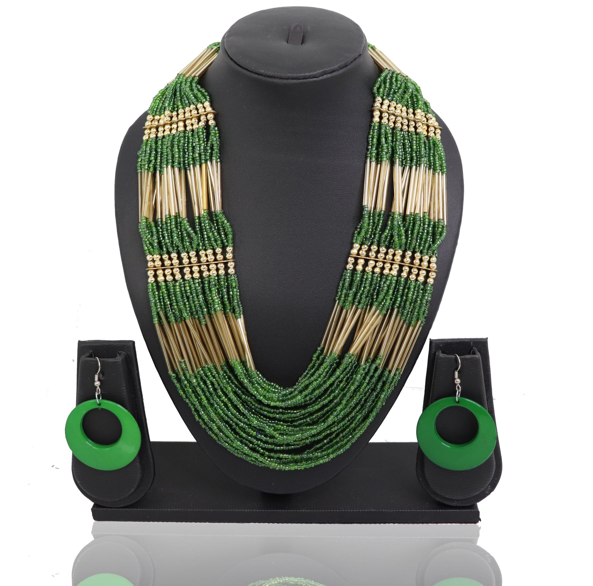 A necklace and earrings set featuring green and beige beads displayed on a mannequin neck and ears respectively.