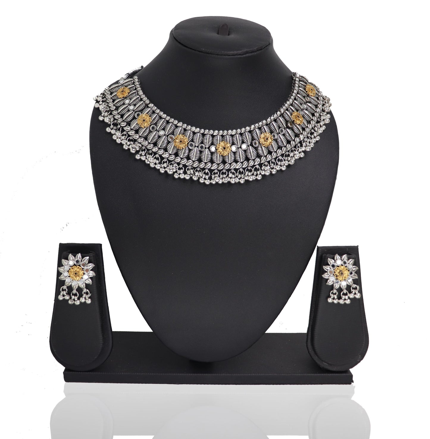 An oxidised silver choker necklace Set with a floral design and a pair of matching earrings displayed on a stand.