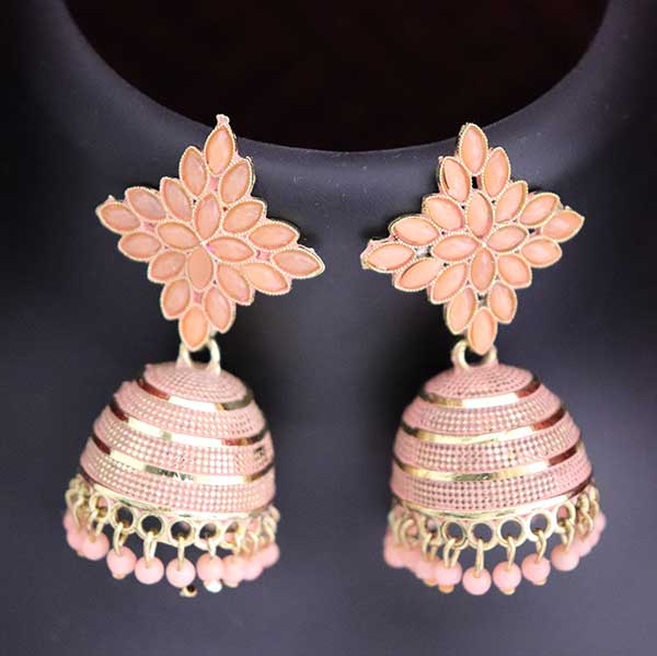 A pair of blush pink floral handcrafted jhumka earrings displayed on a stand.
