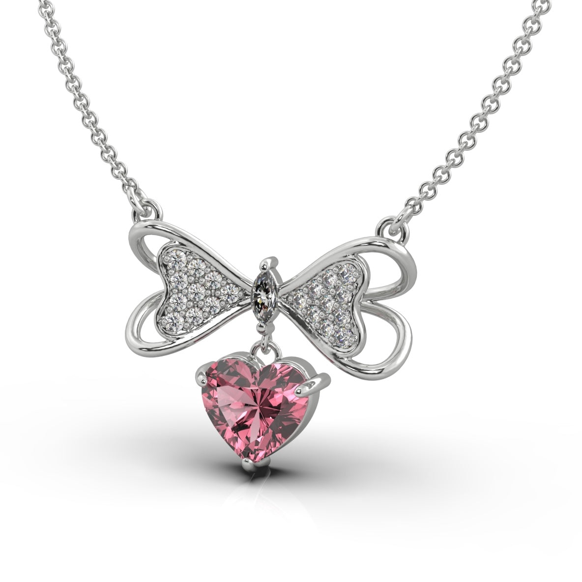 A silver necklace featuring a butterfly-inspired bow with pave-set crystals and a heart-shaped pink gemstone pendant.