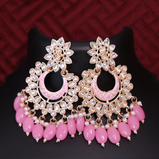 A pair of gold-colored Chandbali earrings featuring pink meenakari kundan-style stones and pink bead accents.