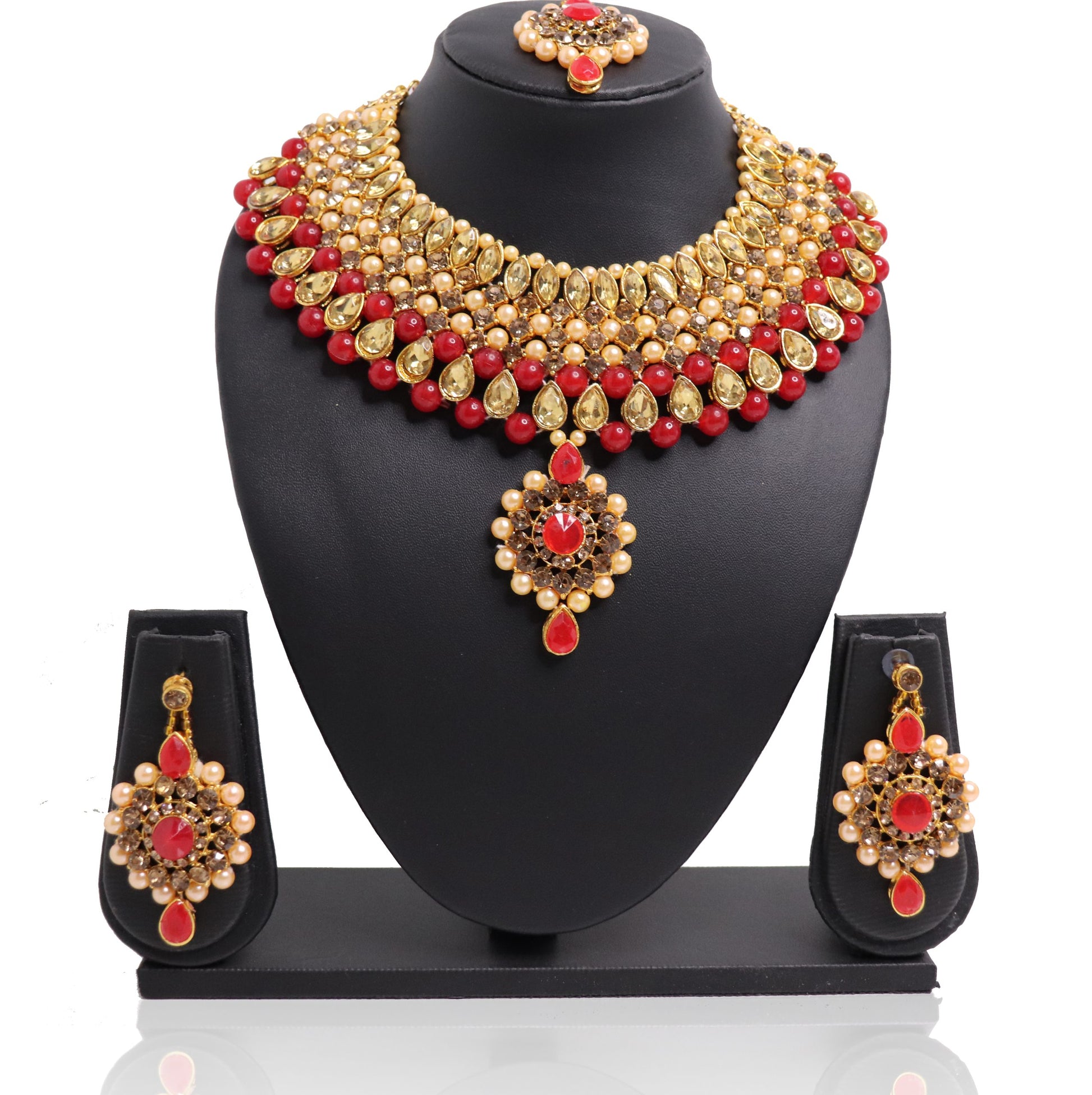 A red and gold necklace set with a pendant and earrings displayed on a mannequin bust.