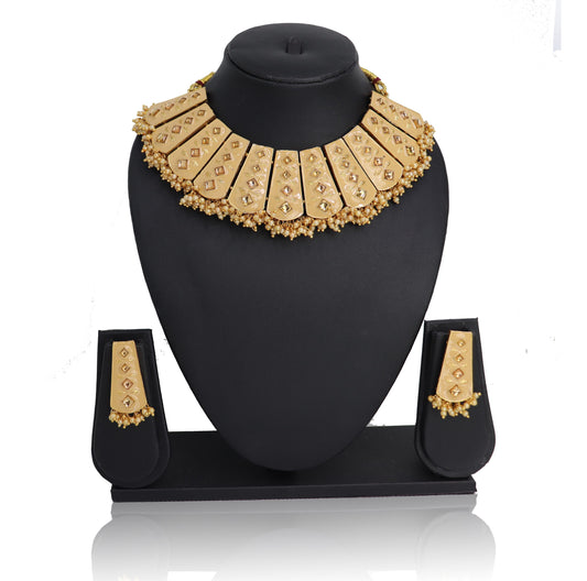 A Necklace set with a golden-colored beaded chain and matching earrings displayed on a black stand.