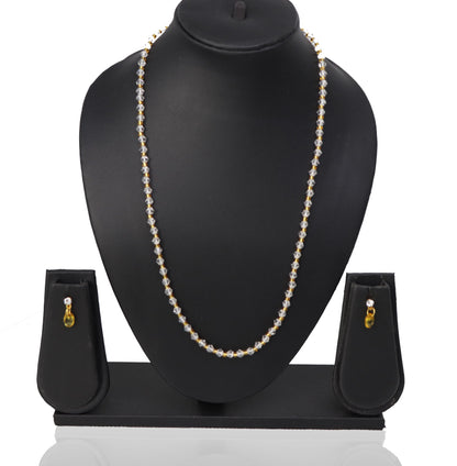 A necklace and three earrings set displayed on a mannequin, featuring white beads and gold-colored accents.